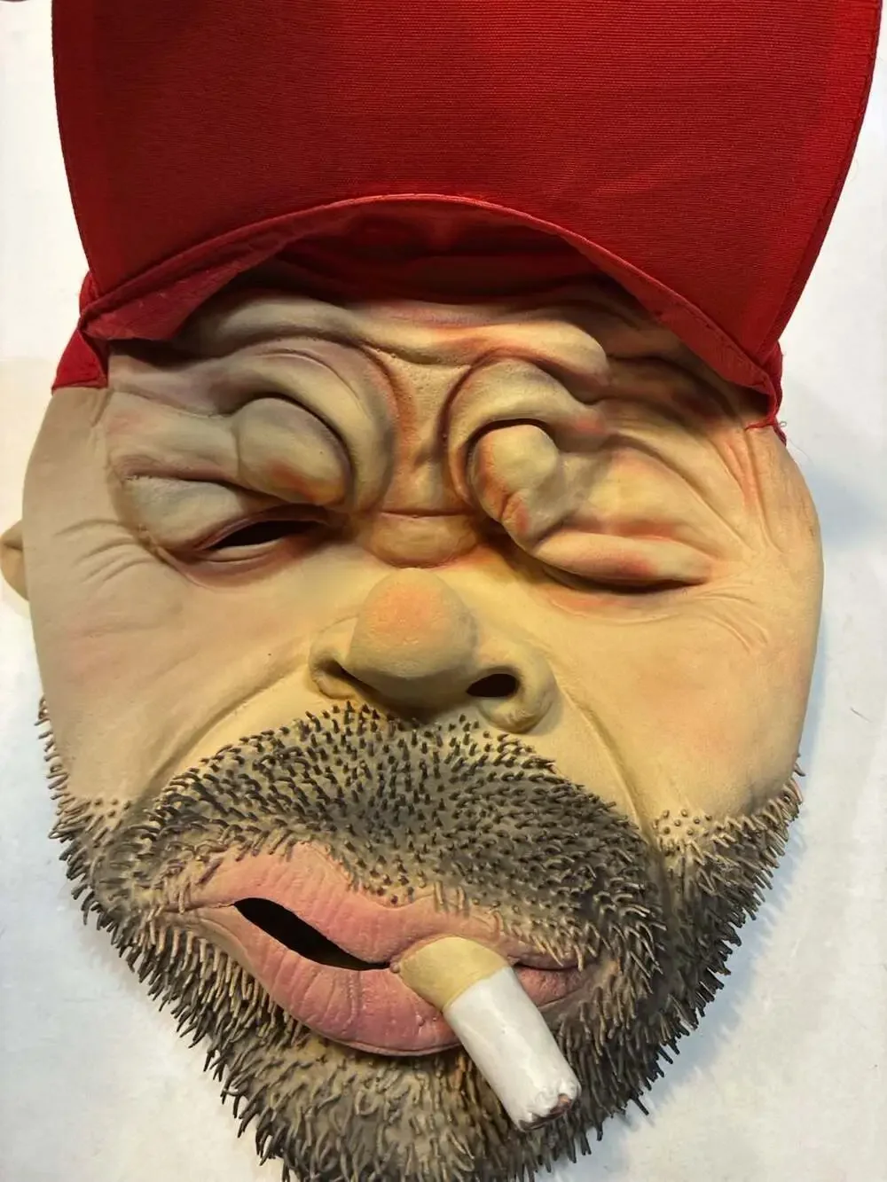 Realistic Man with Beard and Cigarette Latex Novelty Mask with Red Cap
